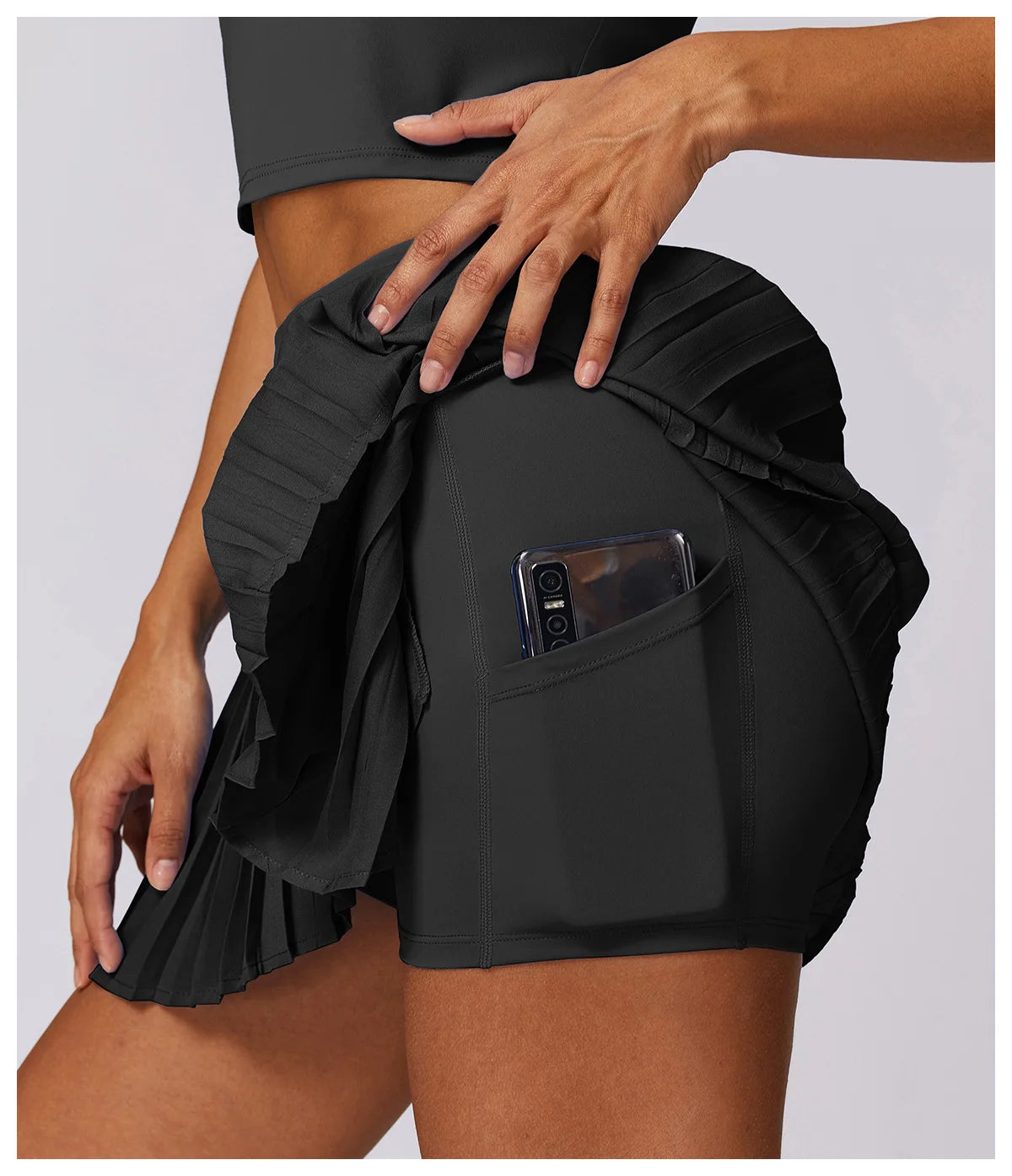 Black athletic pleated tennis skirt with shorts and phone pocket