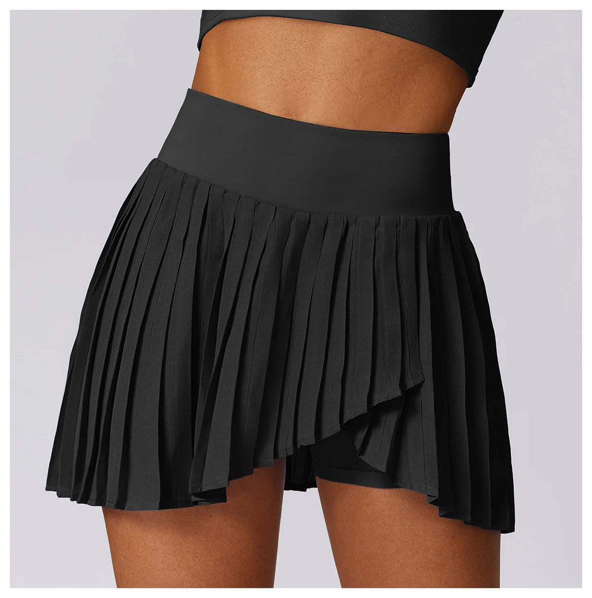 Black high-waisted pleated athletic skirt with built-in shorts, women's activewear