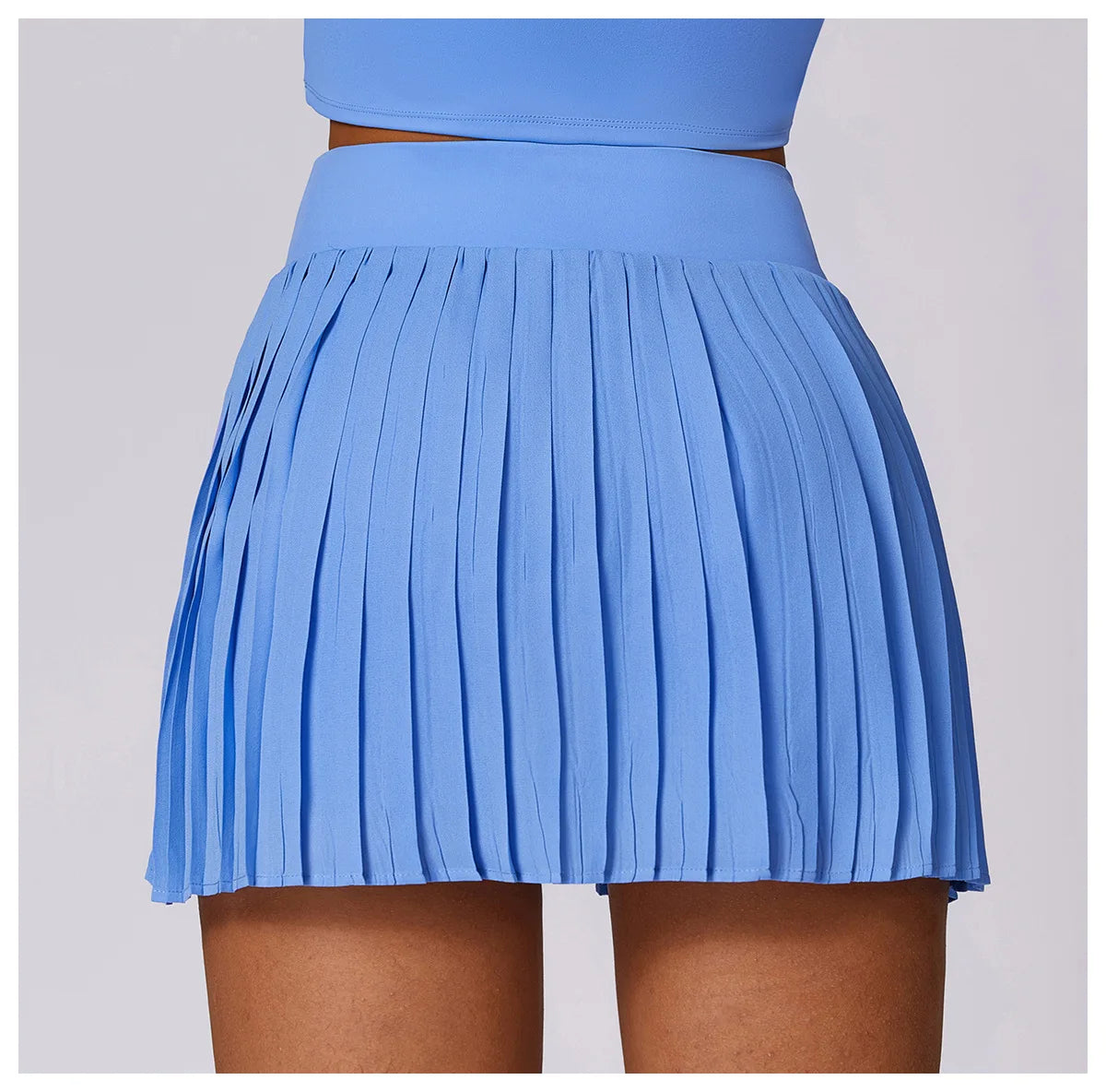 Light blue pleated mini skirt with high waist on model